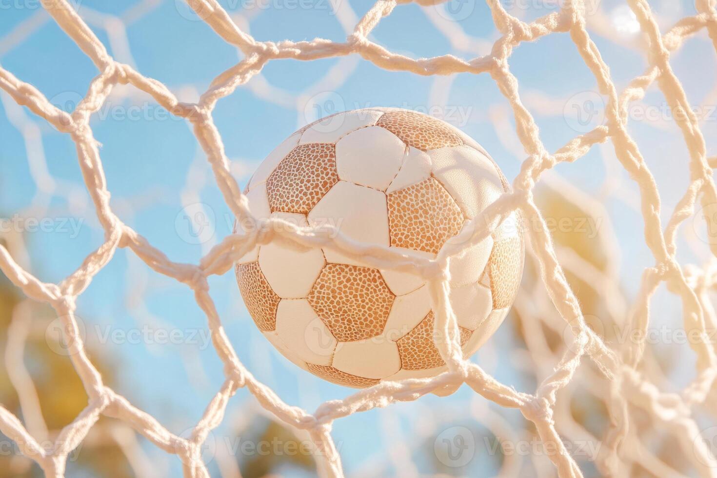 Pink soccer ball hits the net in a goal on a blurred background photo