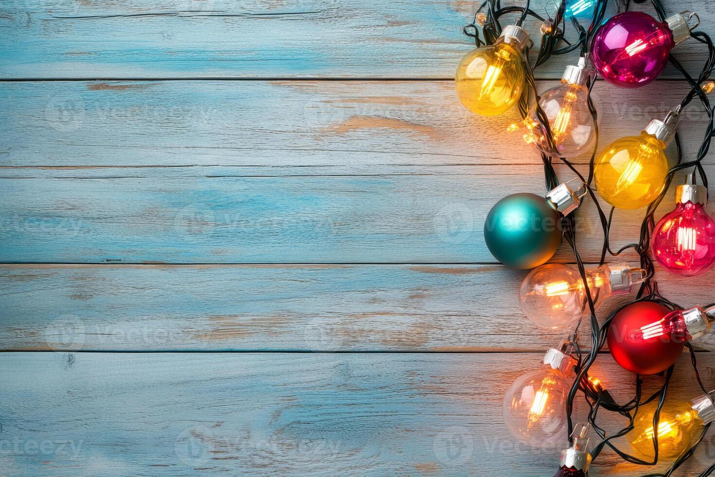 Christmas baubles and string lights on a rustic wooden surface photo