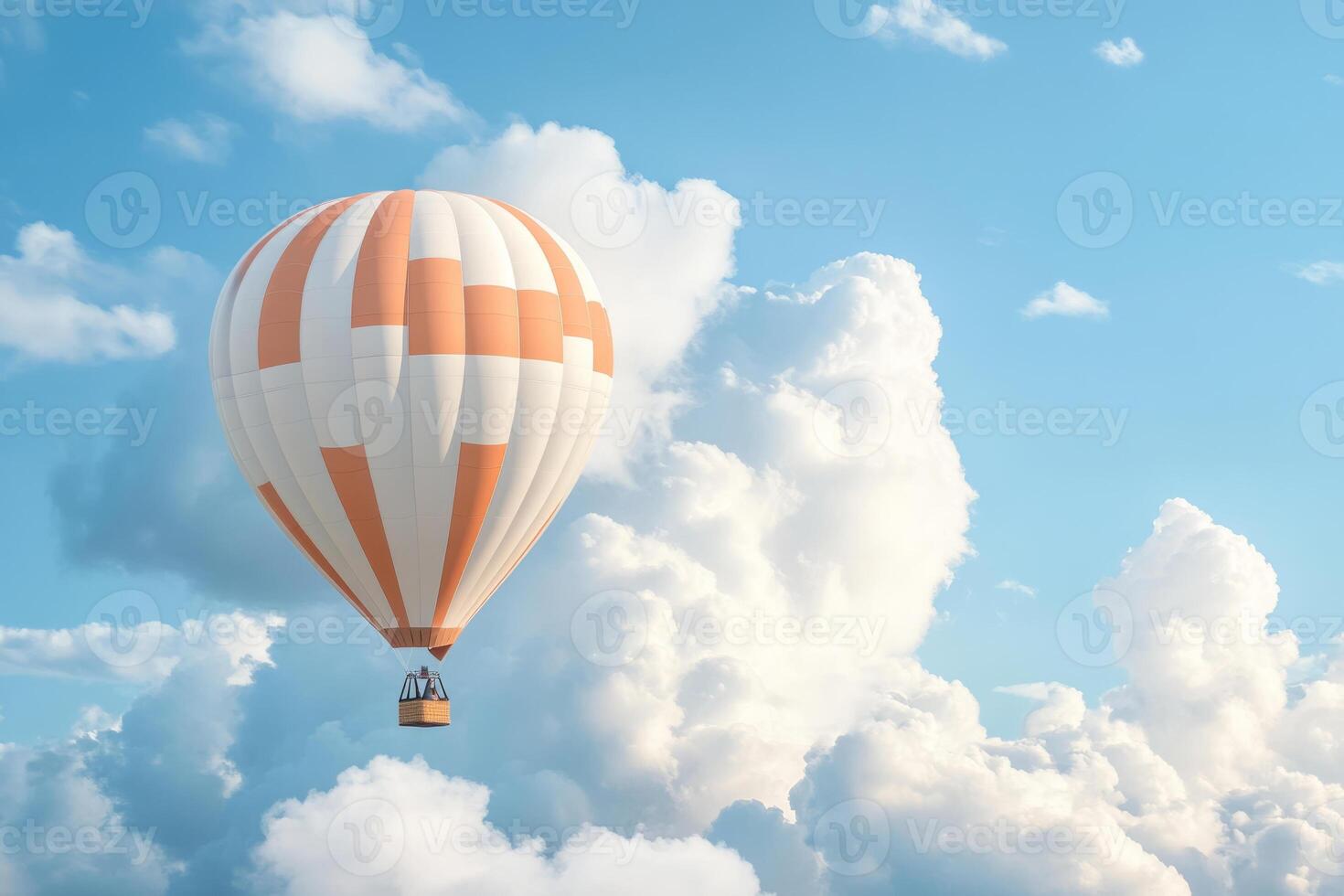 Hot air balloon floating in blue sky surrounded by soft clouds photo