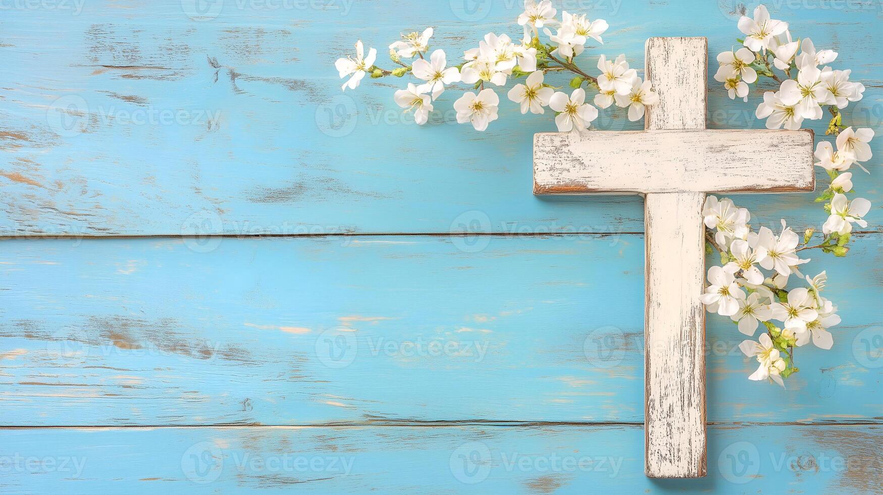A rustic wooden cross adorned with white flowers on a serene blue background photo