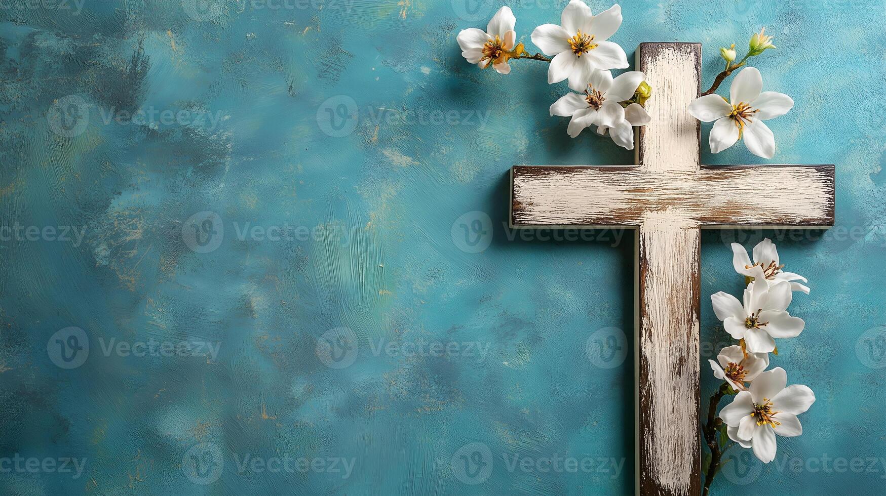 A wooden cross adorned with white flowers on a serene blue background in a spiritual setting photo