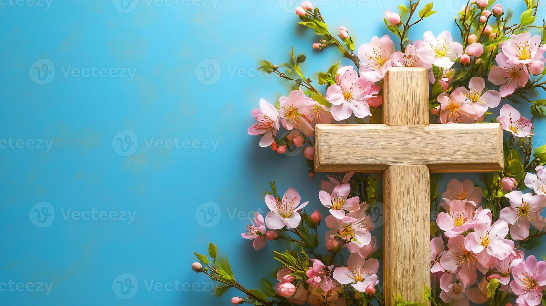 A wooden cross surrounded by delicate pink flowers on a serene blue background photo