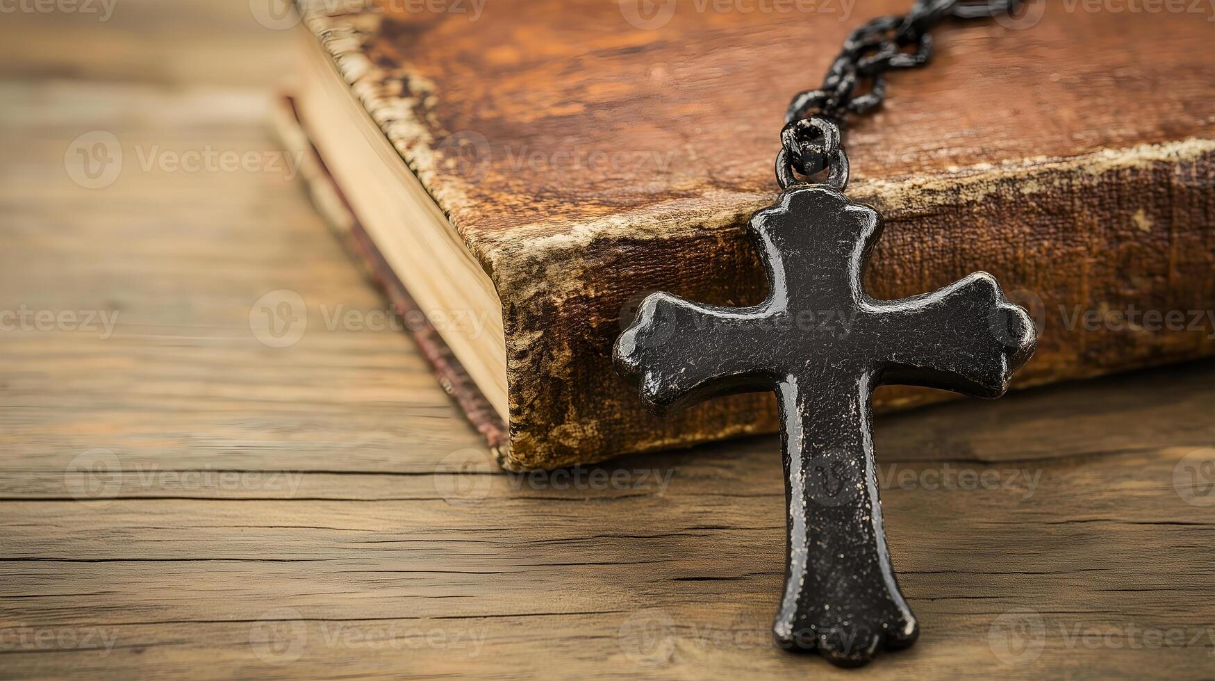 A close-up of a cross resting on an old book background with copy space photo