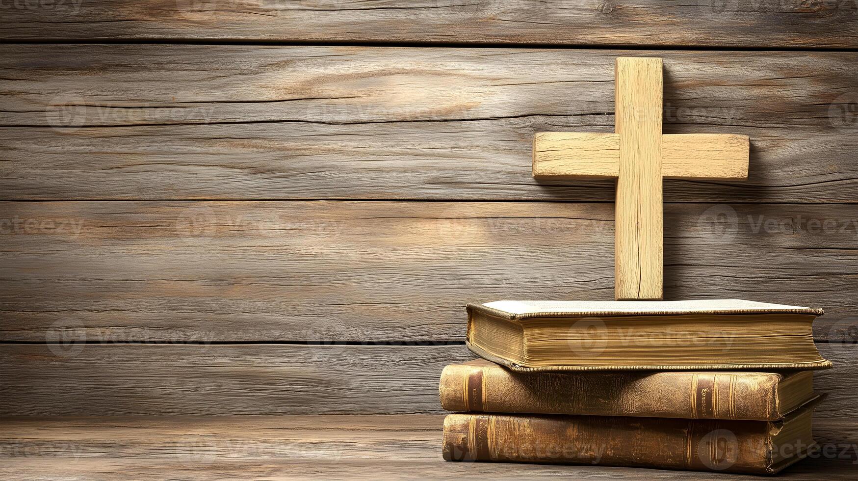 A wooden cross resting on two stacked books against a rustic wooden background photo