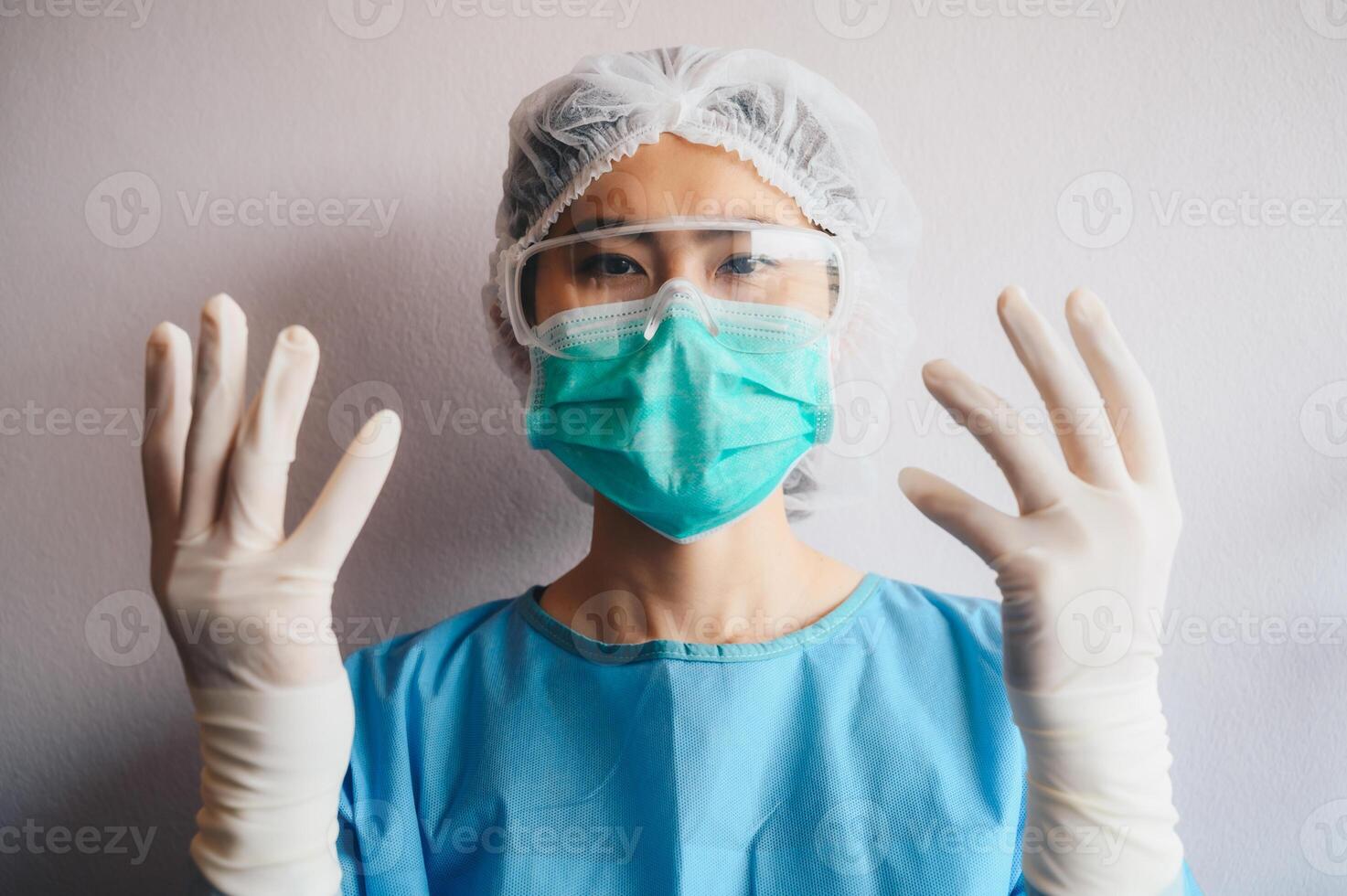Asian nurse raised her hands and wearing rubber gloves before working in hospital. Conceptual of healthcare worker while working in hospital or clinic. photo