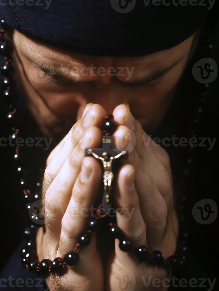 A person praying with a rosary in hand during a moment of spiritual reflection photo