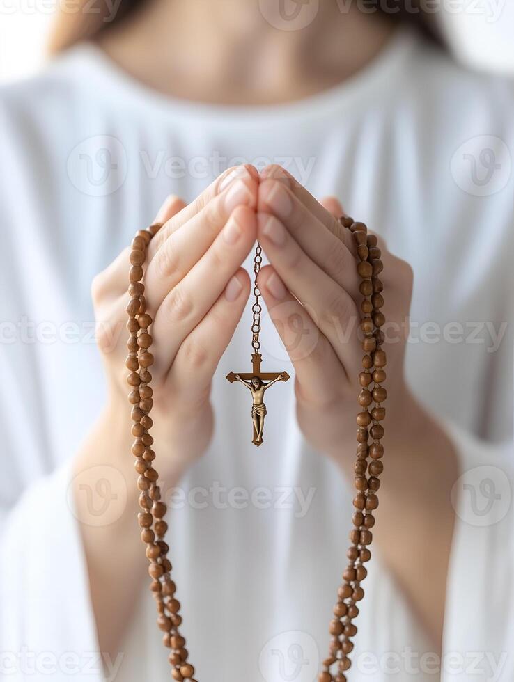 A person praying with a rosary in their hands, reflecting faith in a quiet moment of devotion photo