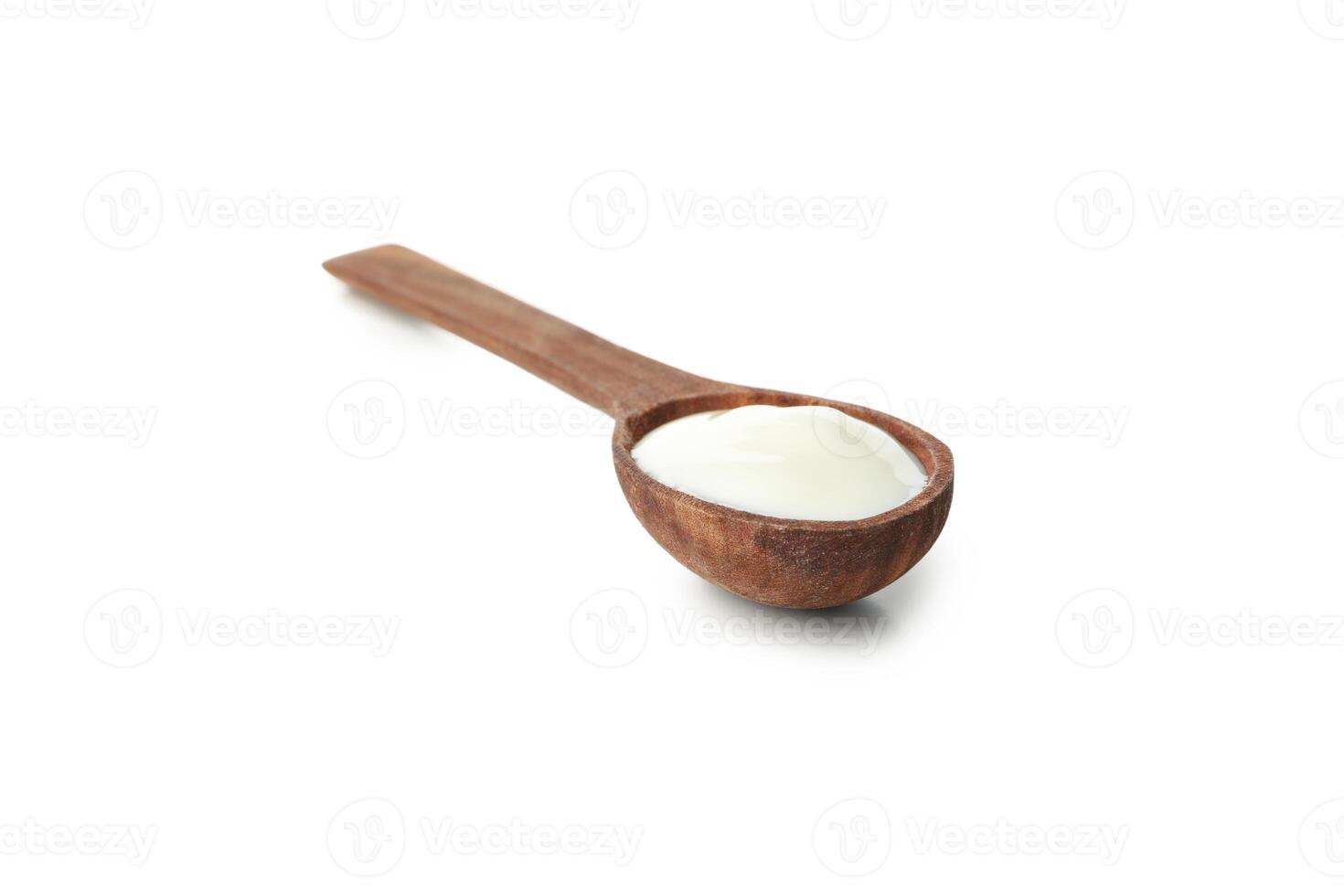 Spoon with sour cream yogurt isolated on white background photo