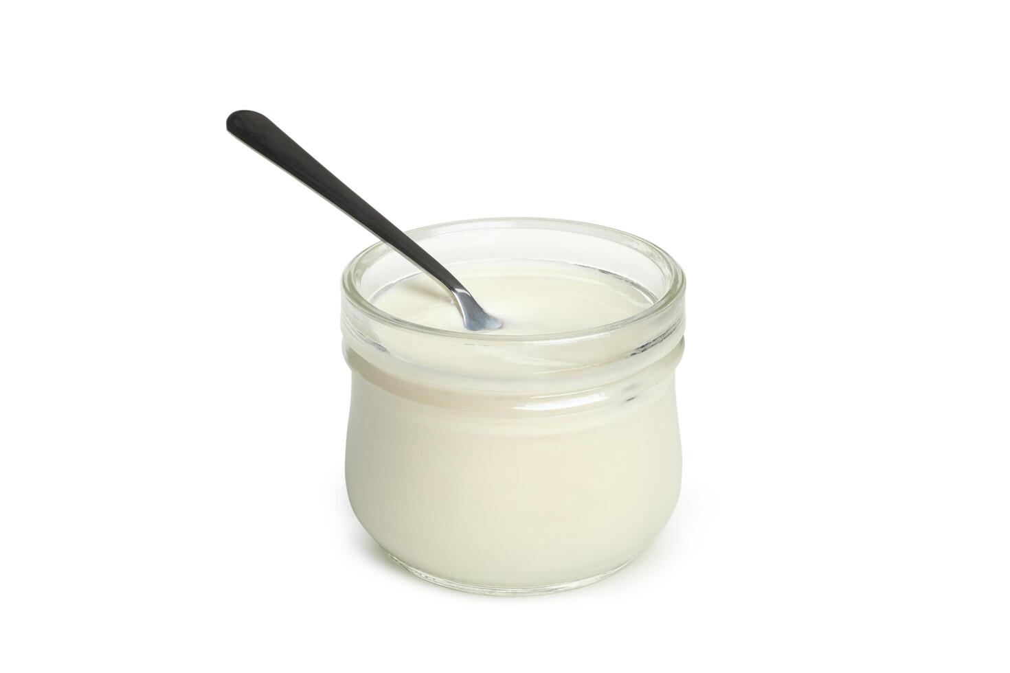 Glass jar of sour cream yogurt and spoon isolated on white background photo