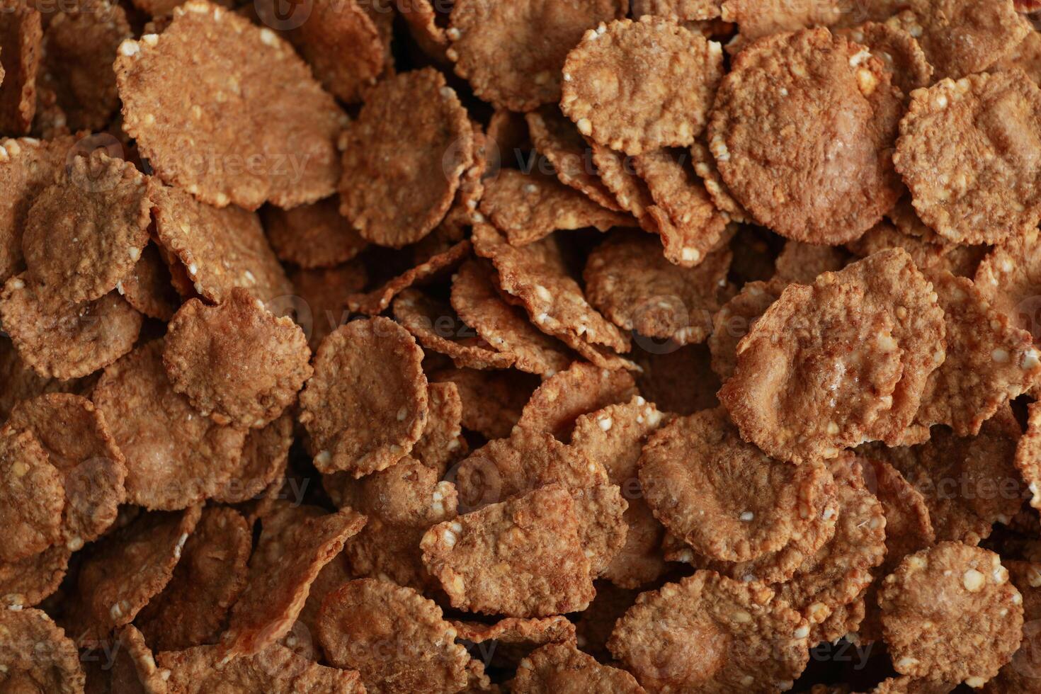 Tasty chocolate muesli on whole background, close up photo