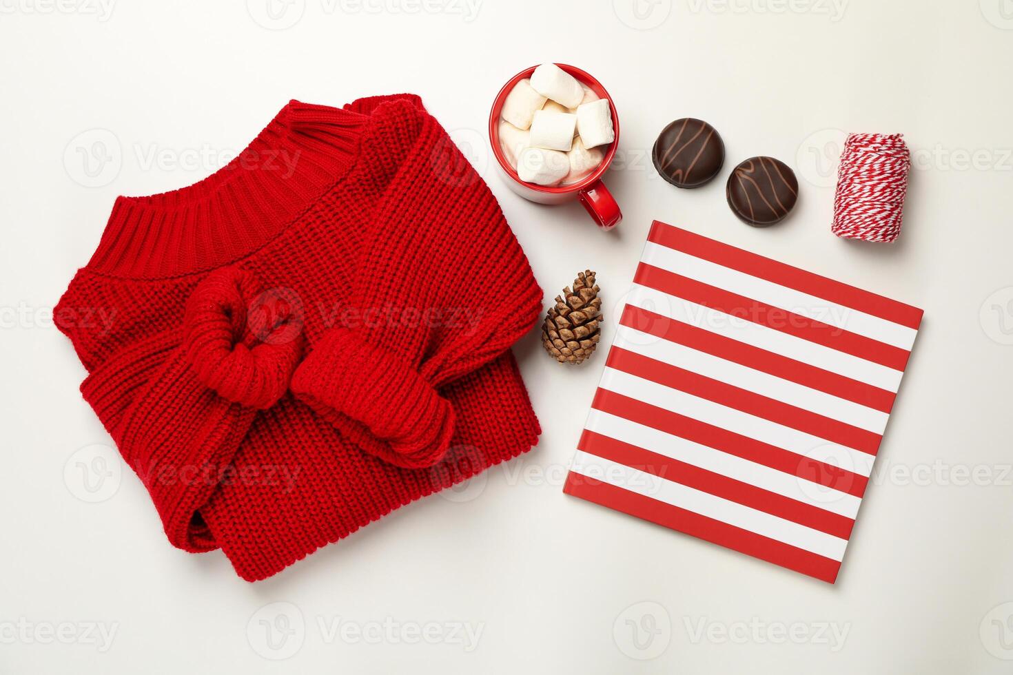 Sweater, cup of coffee with marshmallow, cone, copybook, biscuits and string on white background photo