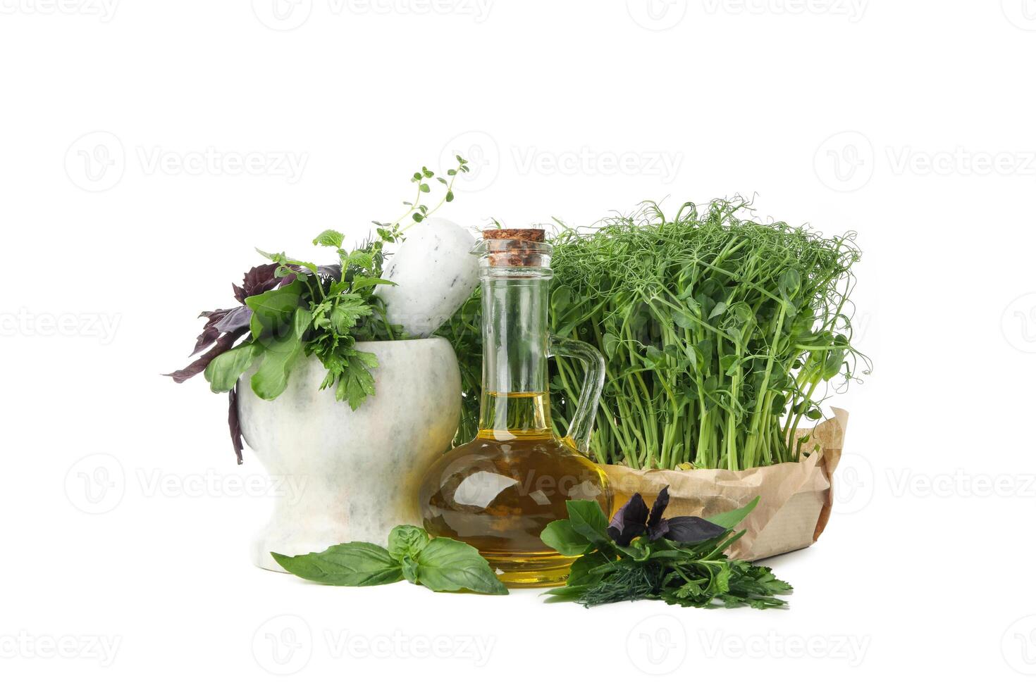 Different herbs, oil and marble mortar isolated on white background photo