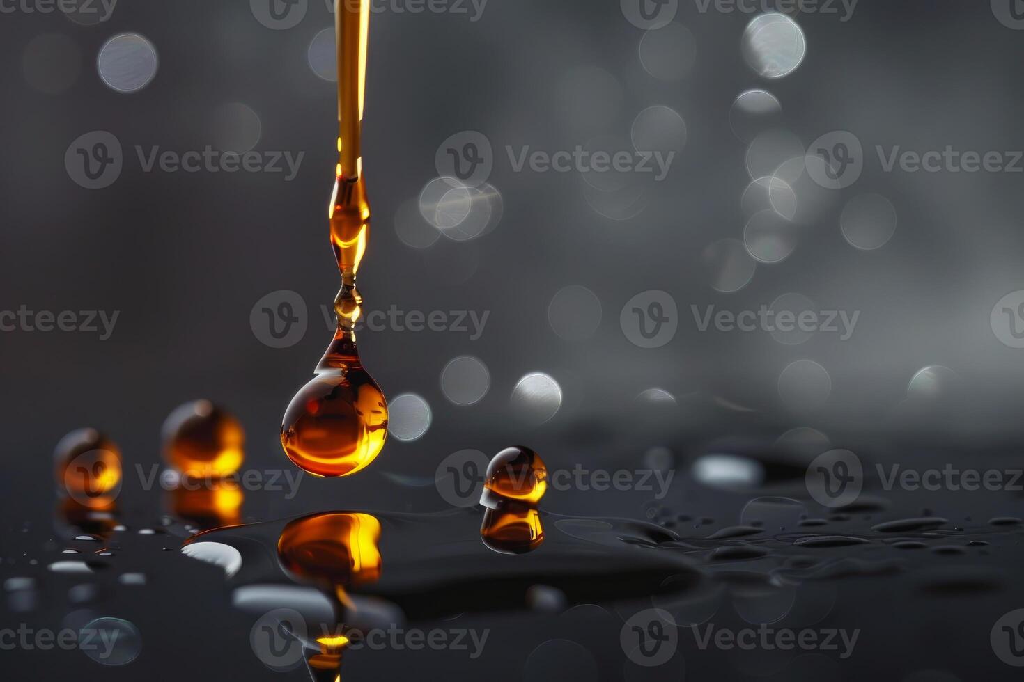 Golden liquid drop forming splashing on wet surface photo