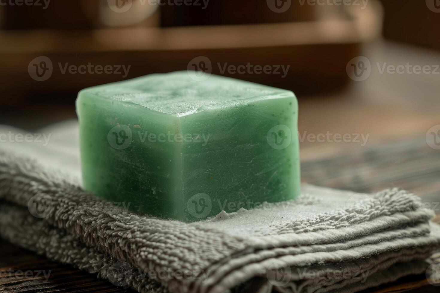 Green soap bar resting on a towel on a wooden table photo