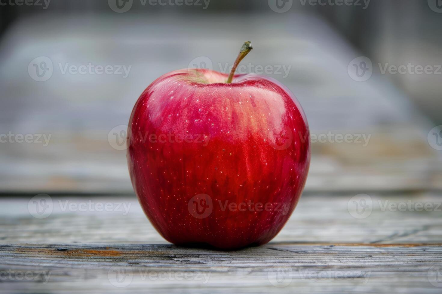 Red apple sitting on rustic wooden surface photo