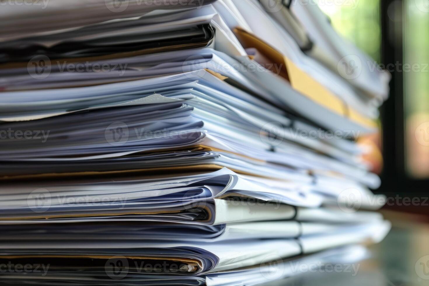 Stack of paperwork sitting on desk representing busy office work photo