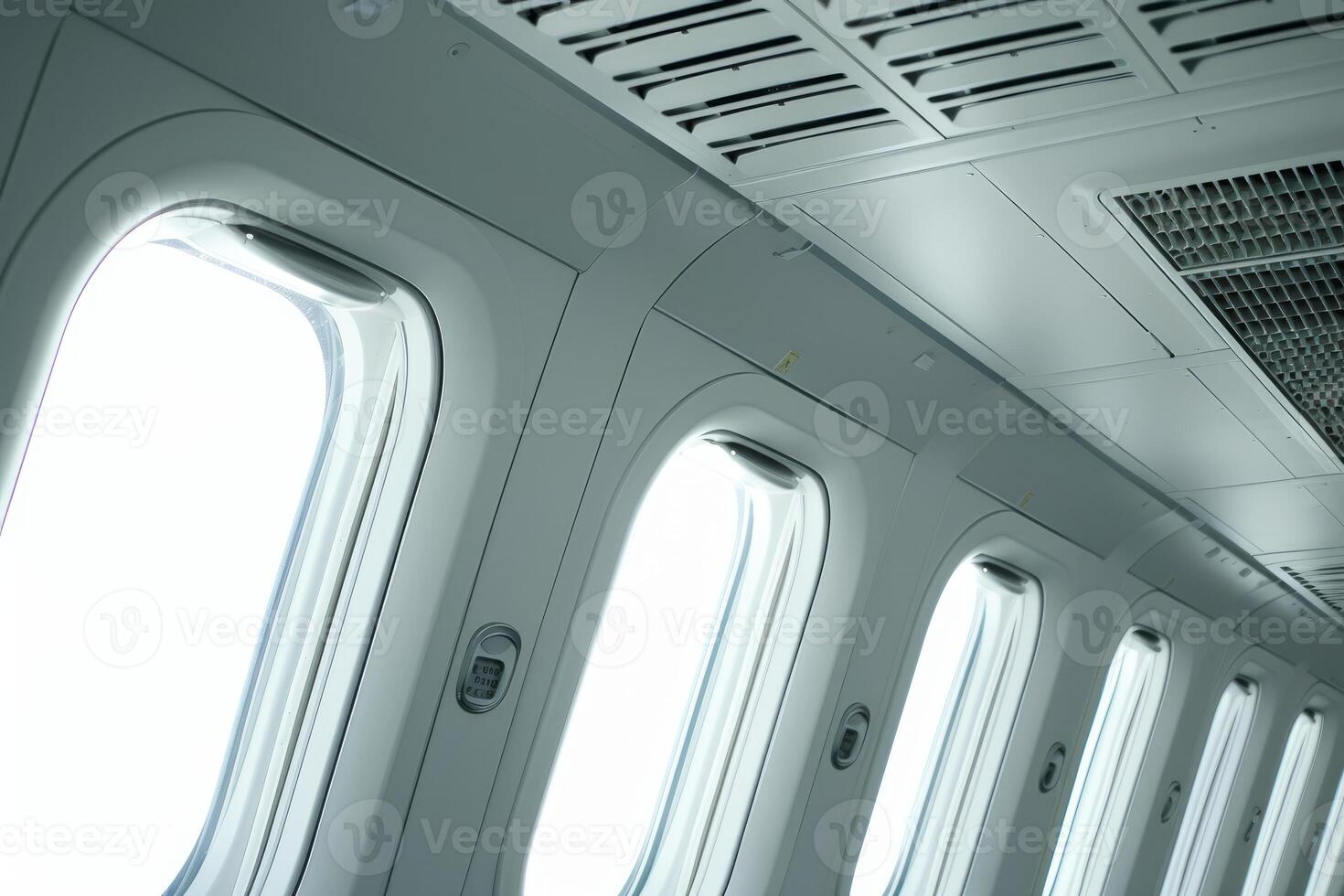 Row of airplane windows showing bright sky photo