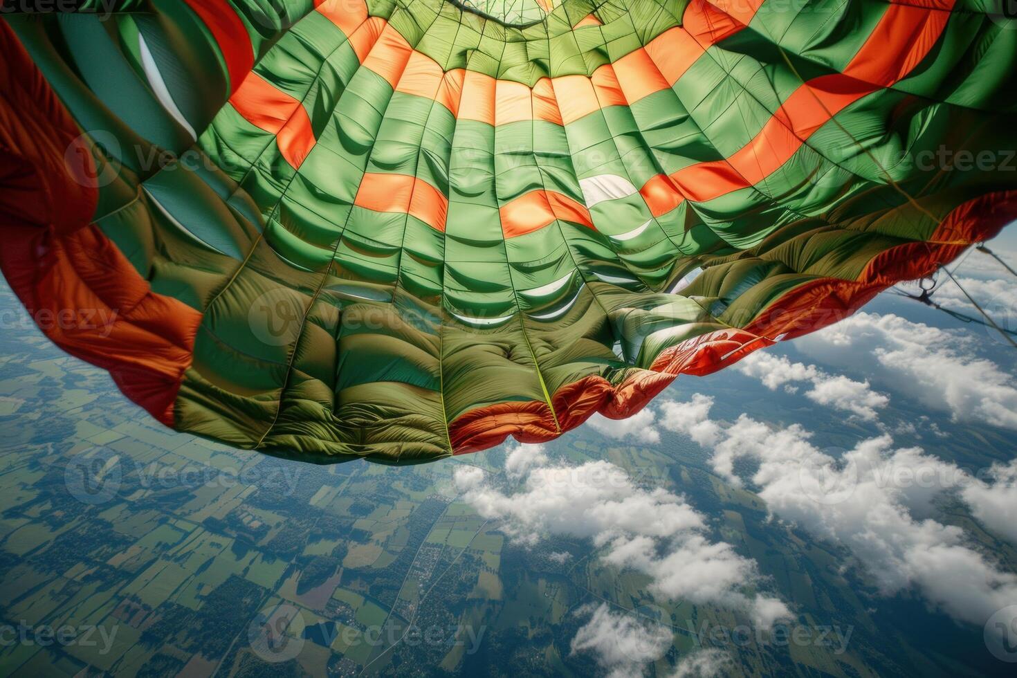Hot air balloon showing its underside while flying high in the sky photo