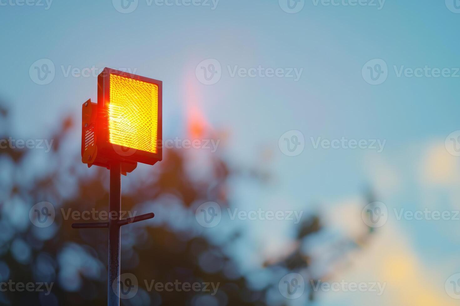 Orange light is shining from construction site warning sign photo