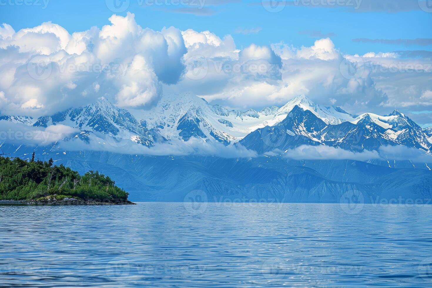 Beautiful alaskan landscape showing snow capped mountains rising over a lake photo