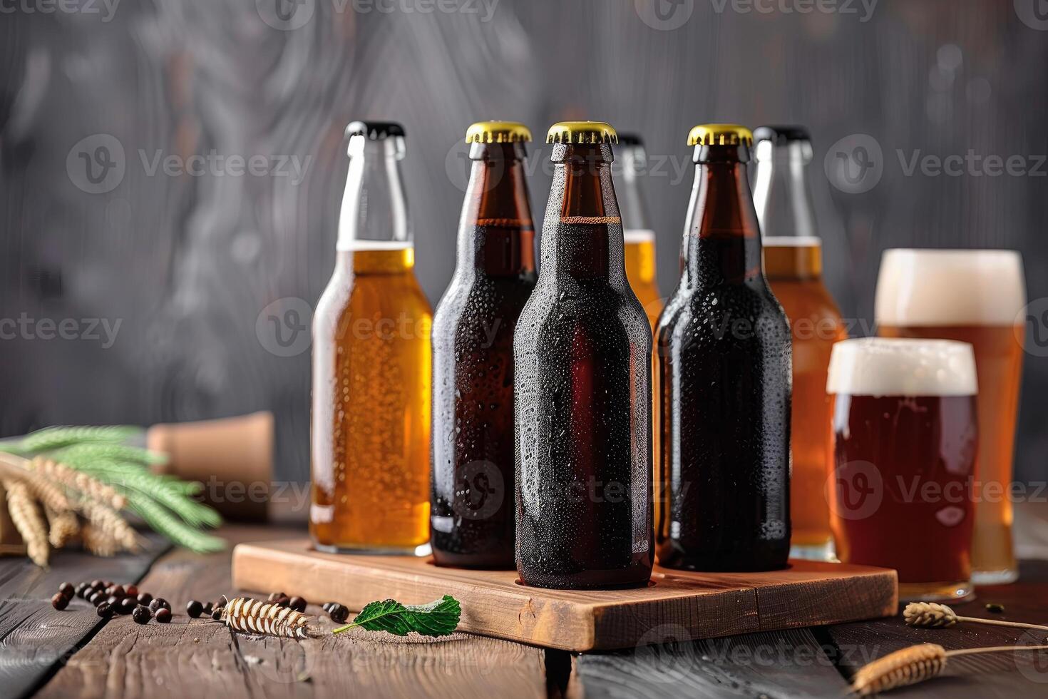 Bottles and glasses of cold beer resting on wooden table photo