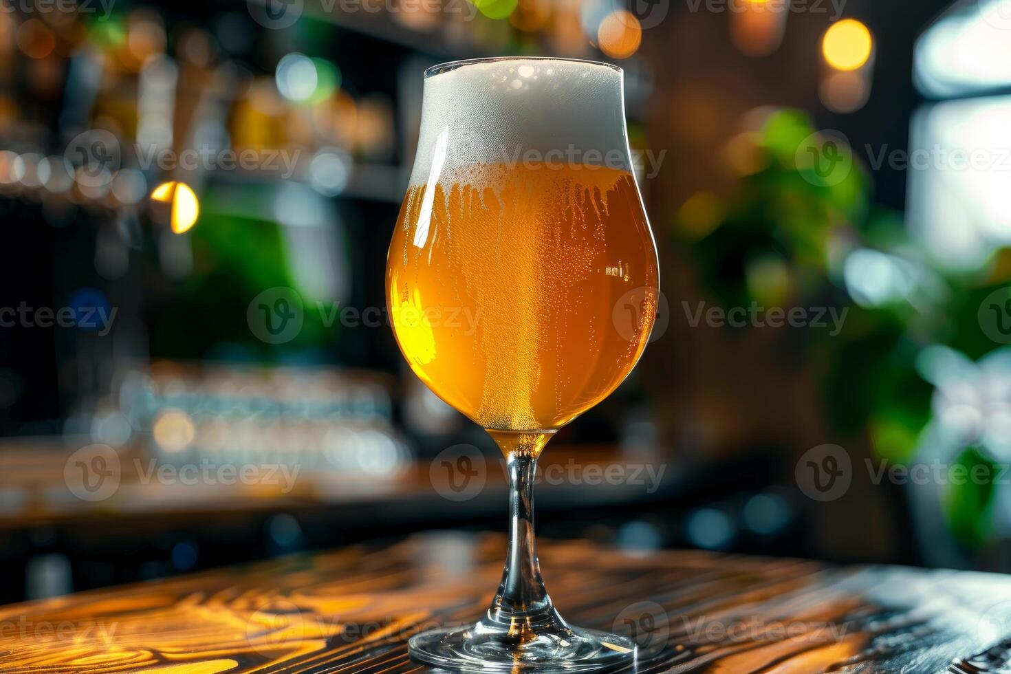 Glass of fresh cold beer standing on bar counter in pub photo