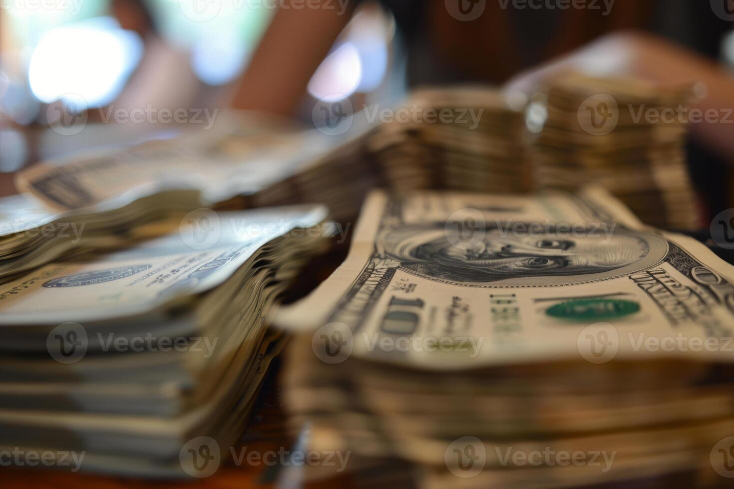 Cashier counting stacks of one hundred dollar bills photo