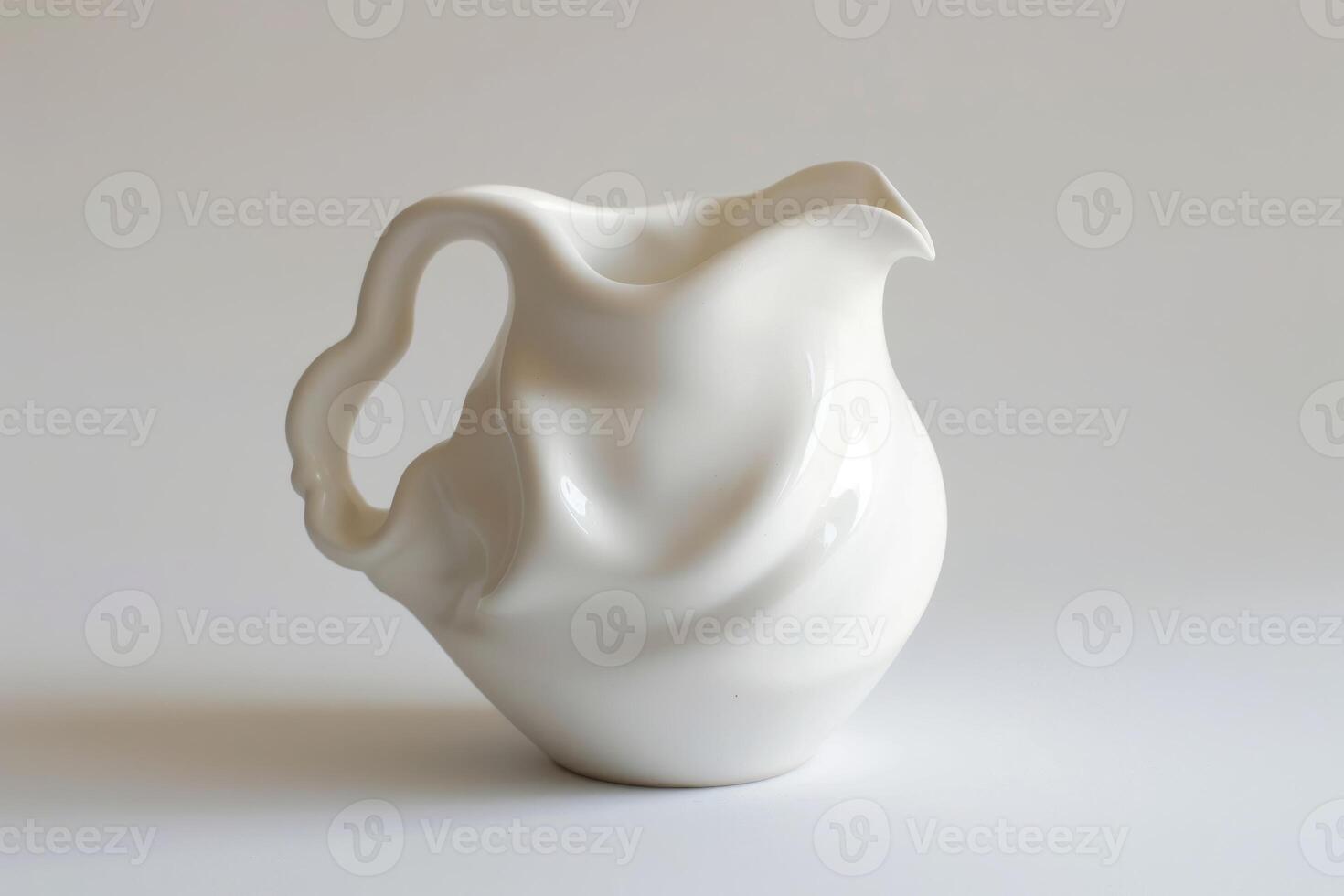 White ceramic pitcher standing on white background photo