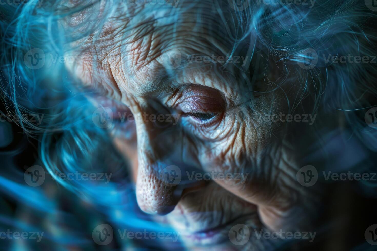 Senior woman experiencing sadness and loneliness in the dark photo