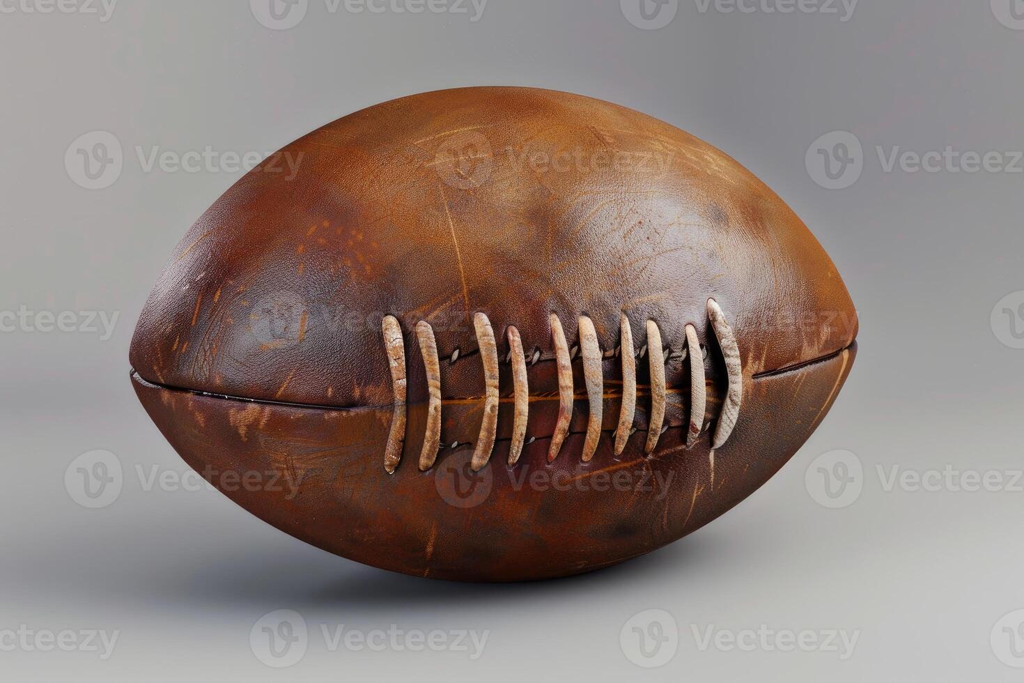 Old worn leather rugby ball with stitches showing its age photo