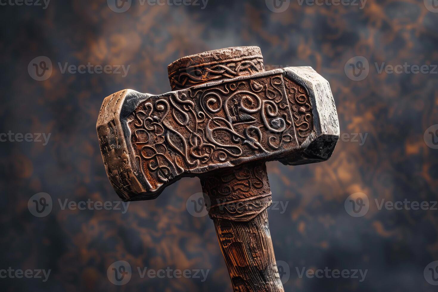 Ancient hammer with intricate engravings is displayed against a dark background photo