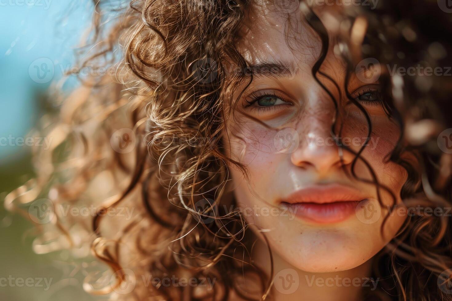 Radiant woman with curly hair close-up photo