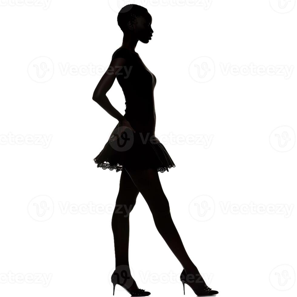 Silhouette of a young woman standing with her hand on her hip photo