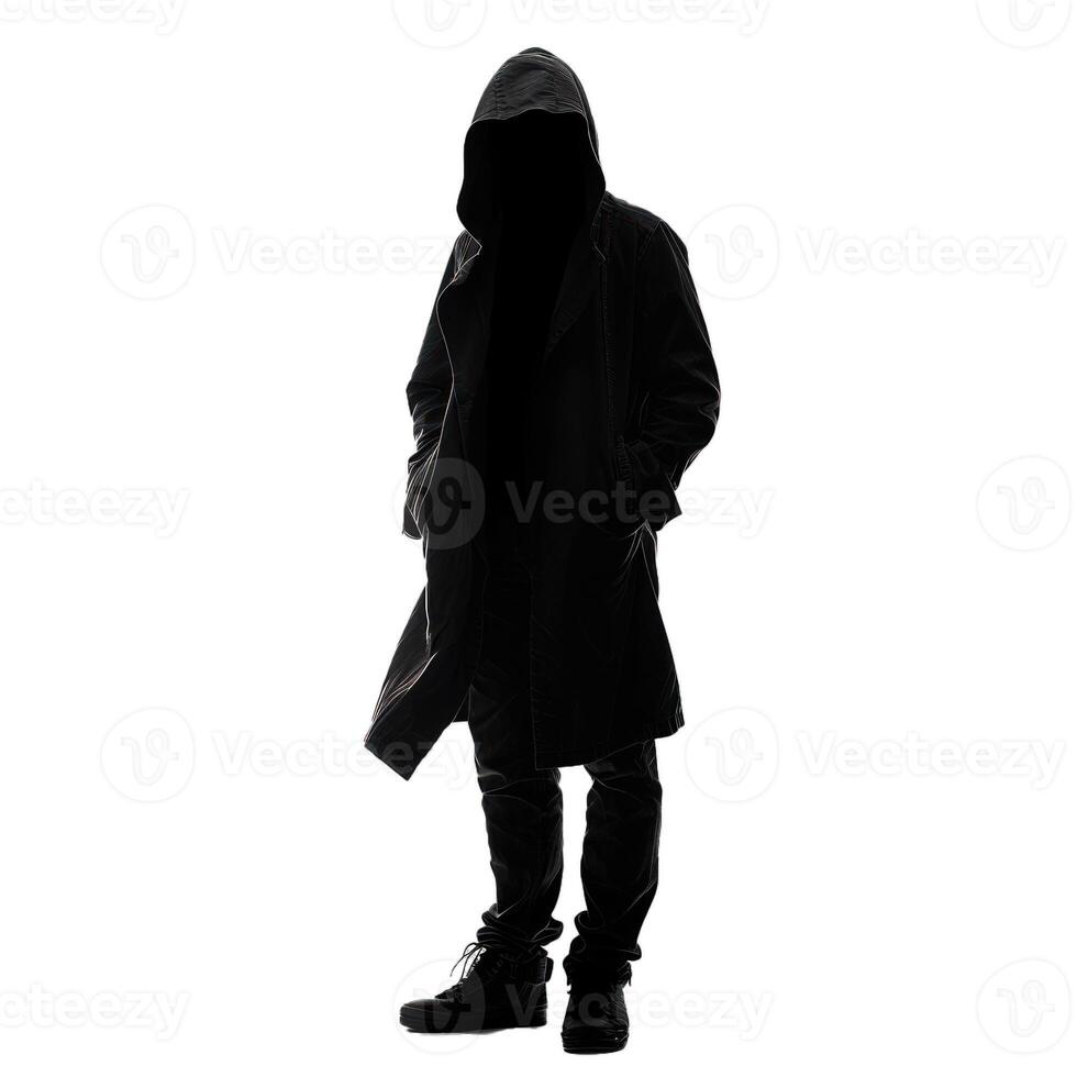 Dark silhouette of a man in a hood with his hands in his pockets photo