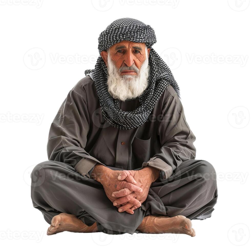 Elderly man in traditional arab attire sitting photo