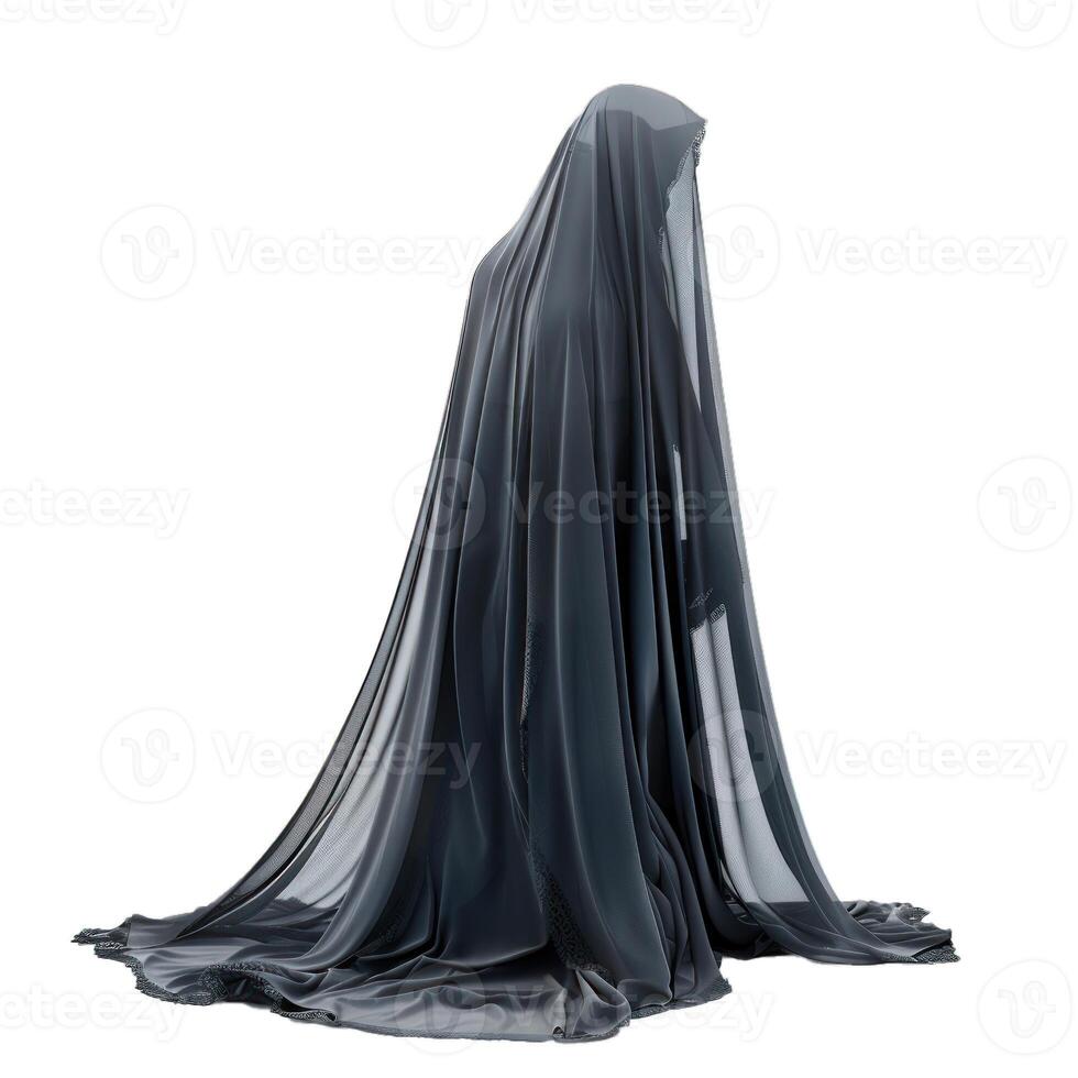 Ghostly figure wearing long flowing black cloth kneeling on ground photo