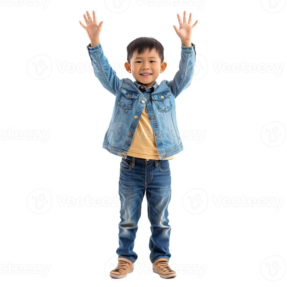 Happy asian boy raising hands while smiling at camera photo