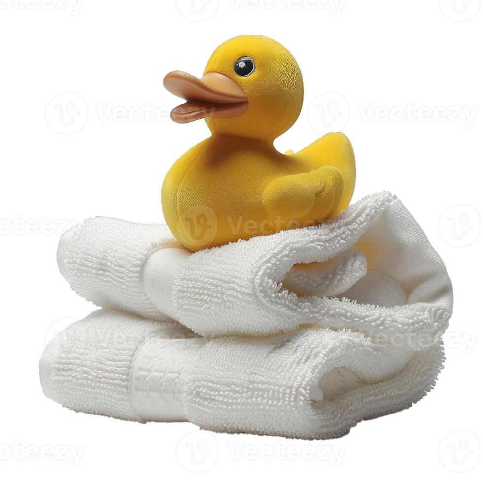 Yellow rubber duck resting on stack of white towels photo