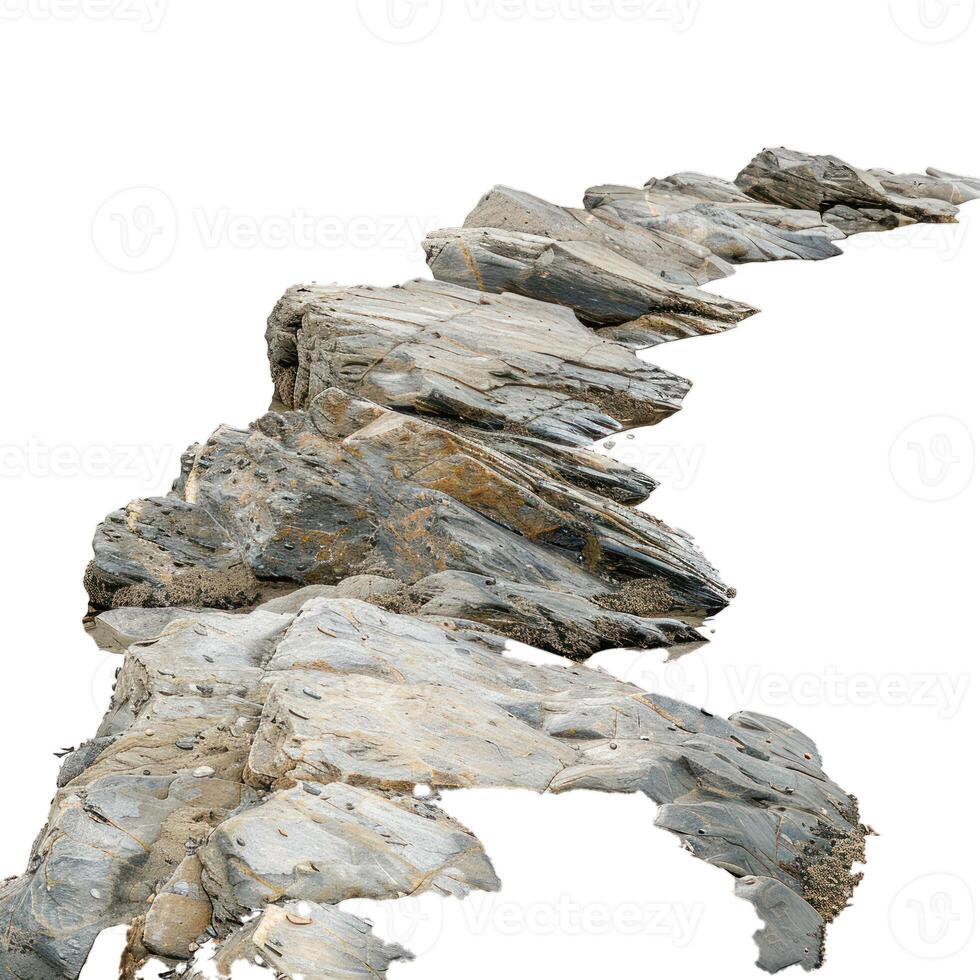 Rocky coastline forming natural path leading to the sea photo