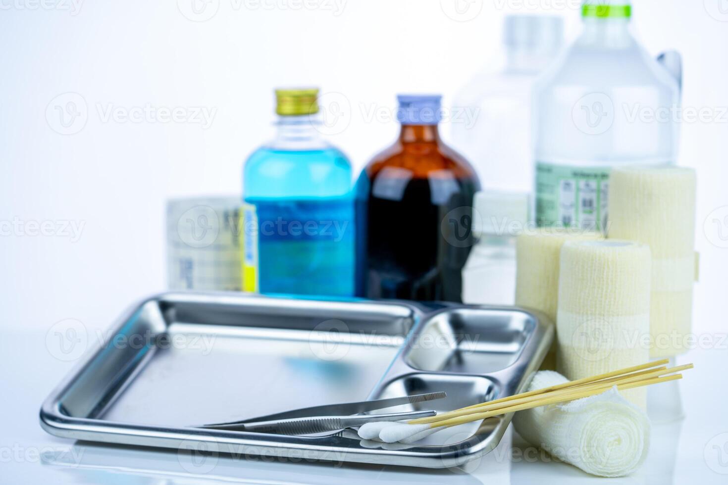 Medical equipment for treating infections. Wound care dressing set. Medical supplies for nurses. Conform bandage, forceps, cotton stick, alcohol. Sterile dressing materials. Healthcare equipment. photo