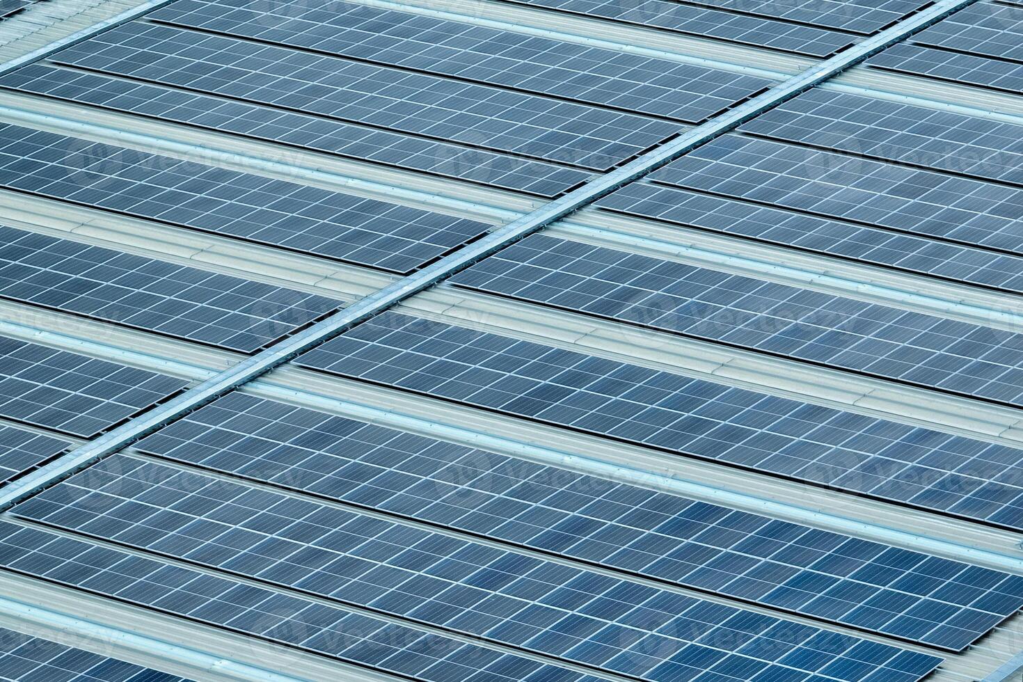 Solar energy for factory and warehouse building. Solar panels on roof of industrial plant. Commercial solar power. Rooftop solar power. Rooftop renewable energy system. Sustainable green energy. photo