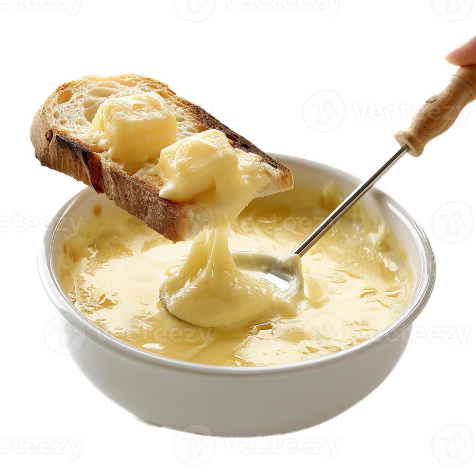 Person dipping bread in melted cheese fondue using a long fork photo