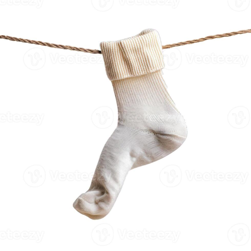 Single white sock hanging on clothesline drying in the wind photo