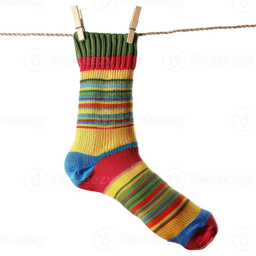 Colorful striped sock hanging on clothesline drying photo