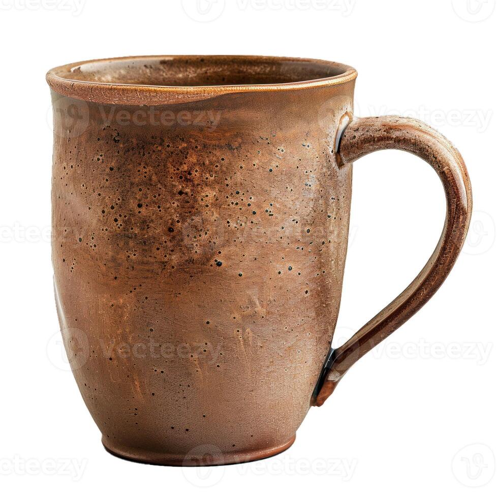Brown handmade ceramic mug standing on white background photo