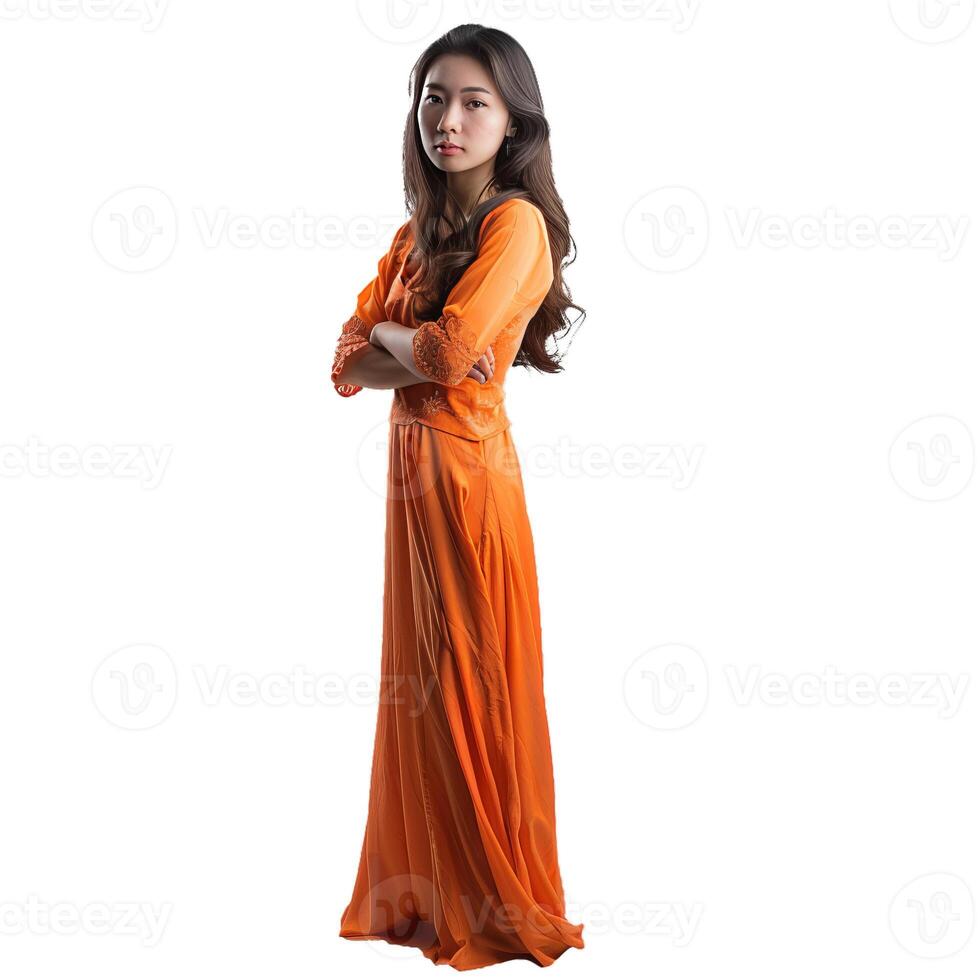 Young woman wearing traditional orange dress is posing with crossed arms photo