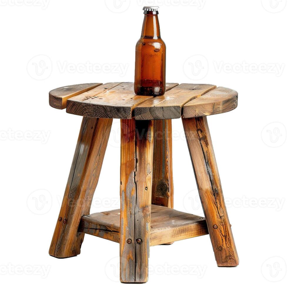 Brown glass beer bottle standing on rustic wooden stool photo