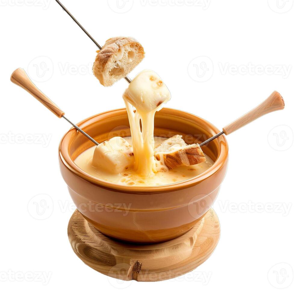 Cheese fondue dipping bread cubes into melted cheese in a ceramic pot photo