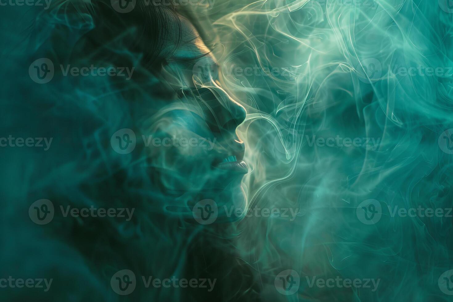 Woman breathing smoke with green lighting effect photo