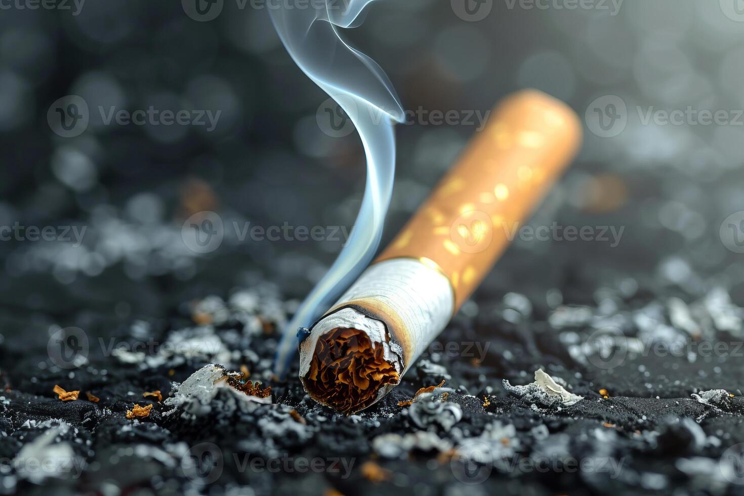 Smoldering cigarette butt resting on ash in ashtray photo